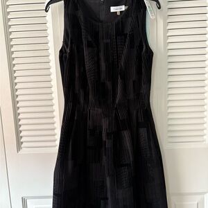 NWT Calvin Klein courdory black dress with varied pattern and side slash pockets